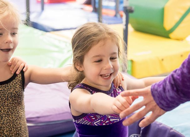Children learning gymnastics skills in class